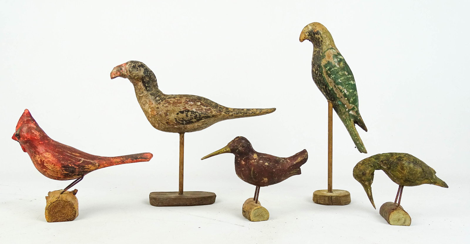 Folk Art Birds: Lot (5) carved wooden painted folk art birds. Largest 10" L., 9" Ht..