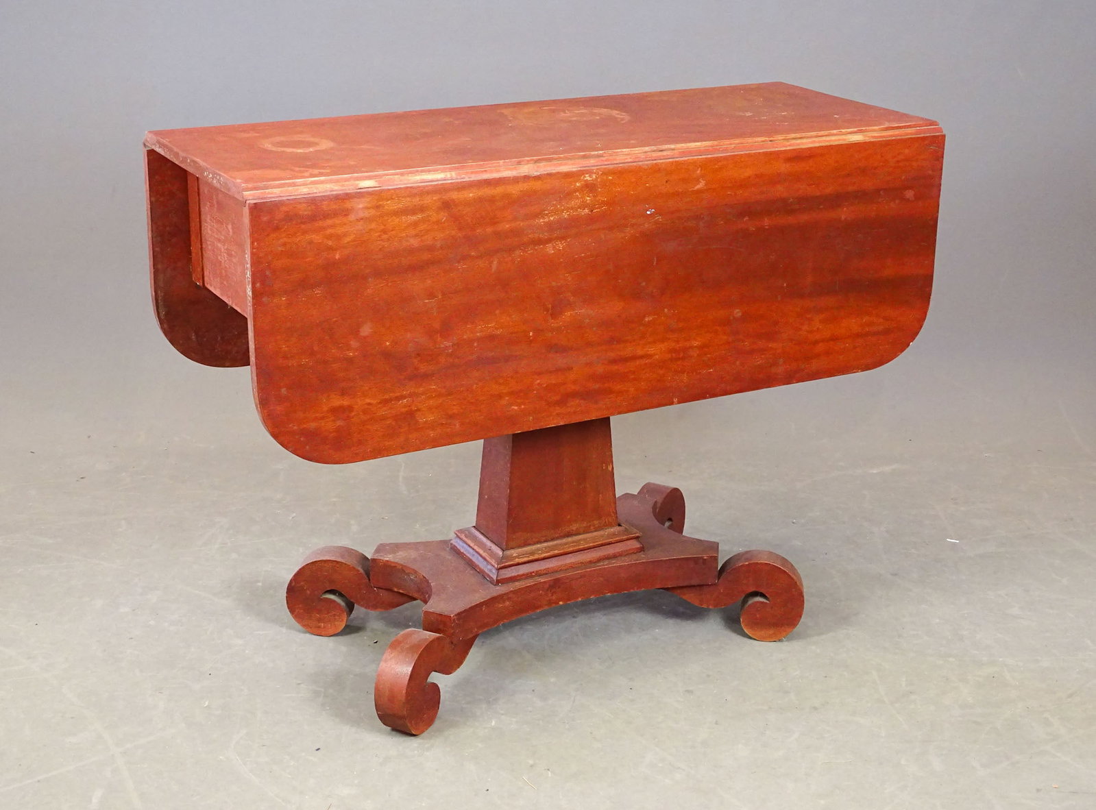 19th c. Empire Dropleaf Table: 19th c. country Empire dropleaf center column table in old red wash. 38" x 14" x 12 1/2" leaves, 28 1/2" Ht..