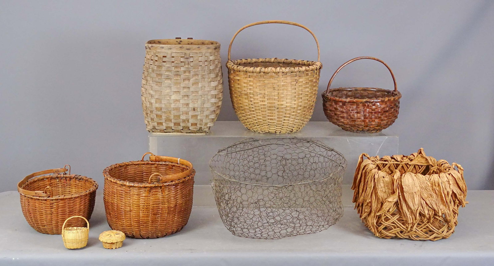 Basket Lot: Lot (7) early baskets. Largest 14" D., 17 1/2" Ht..
