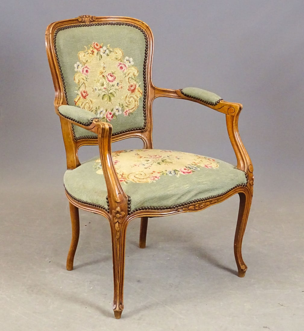 French Louis XV Armchair: French Louis XV style carved armchair with needlepoint upholstery. 16" seat Ht., 34" Ht..