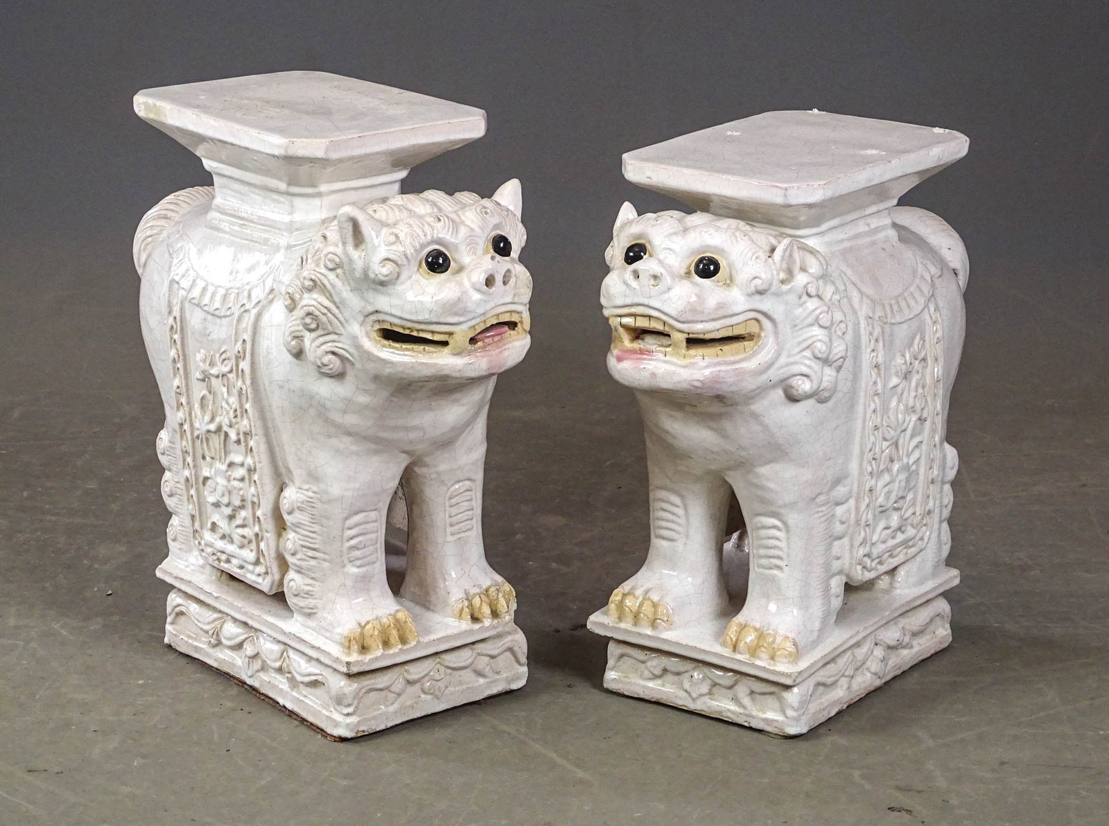 Pair of Foo Dog Stools: Pair of porcelain Foo Dog stools (largest 21" L., 8" W., 20 1/2" Ht.).