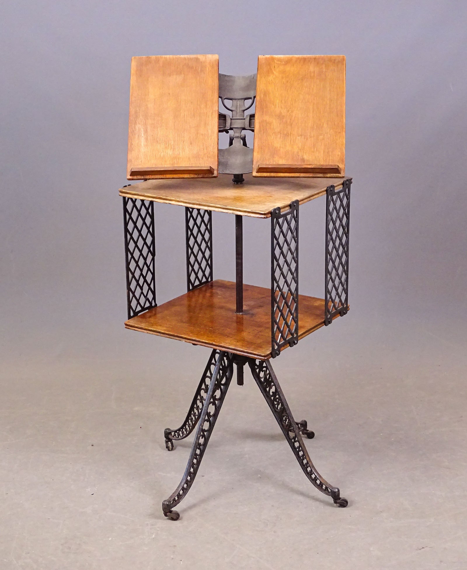 Antique Book Stand: Antique iron and oak revolving book stand. 16" x 16" x 43" Ht..