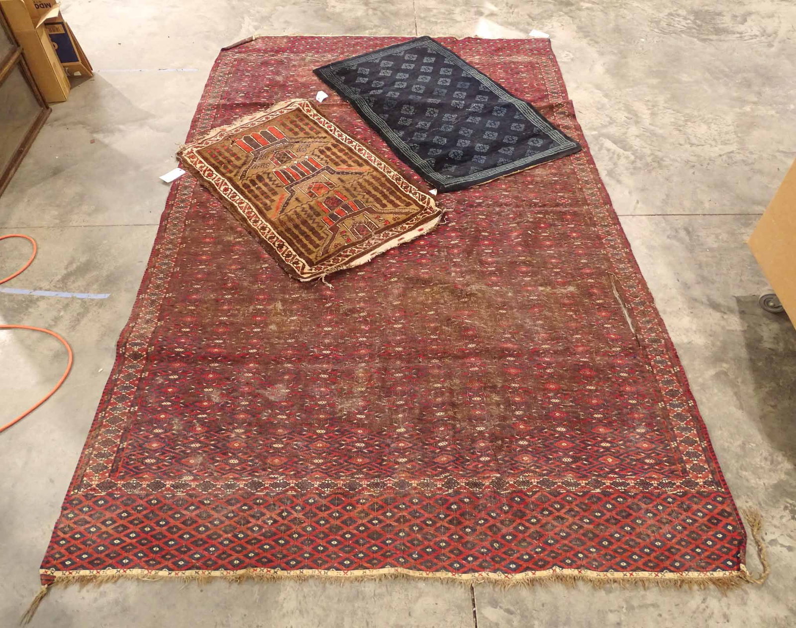 Oriental Rug Lot: Lot of (3) "as found" damaged Oriental rugs. 32" x 48", 34" x 57", 6' 11" x 11' 3".