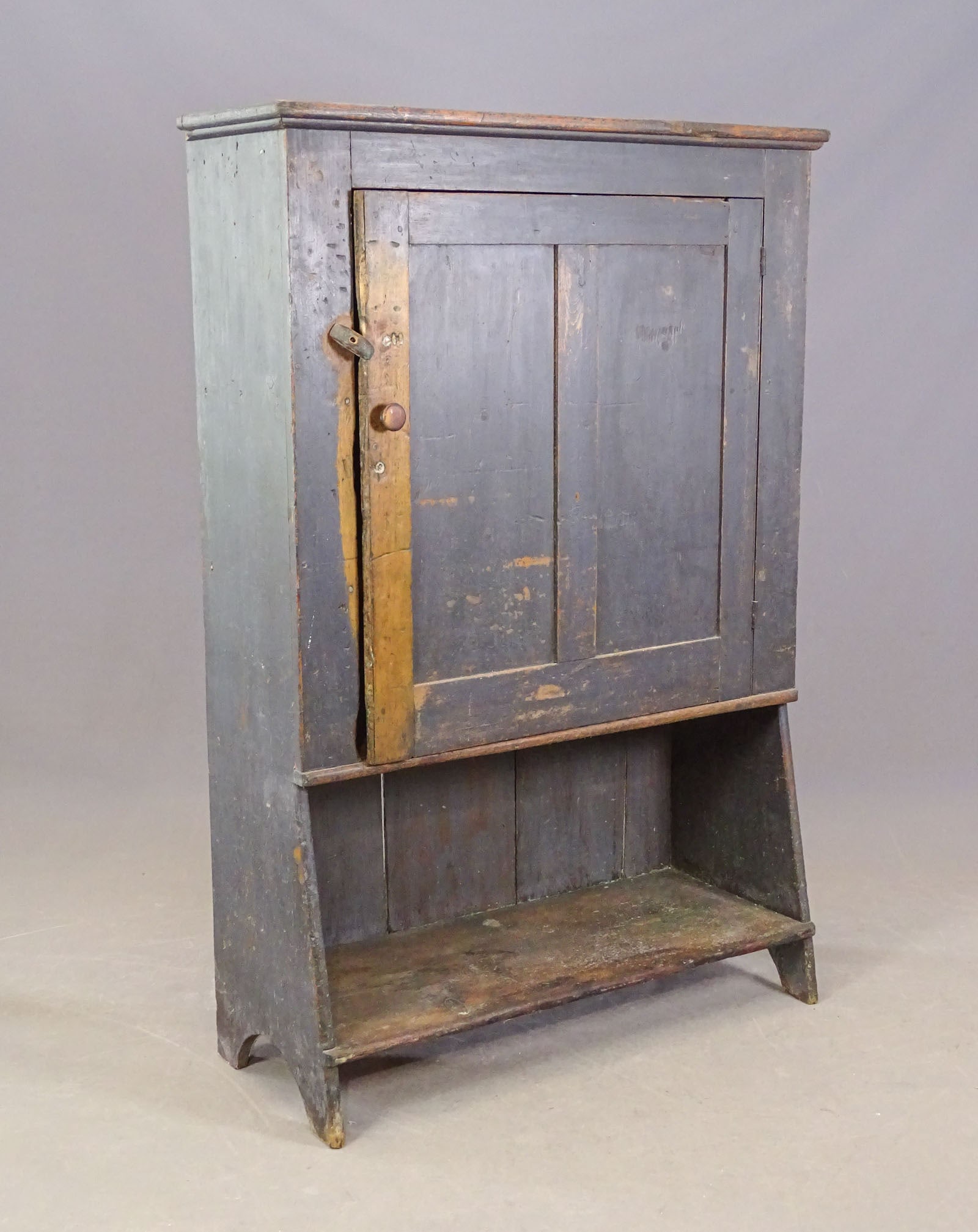 19th c. Bucket Cupboard: 19th c. single door bucket cupboard with under-shelf. Old paint surface. 43" x 17" x 66" Ht.. Bootjack cut-out sides.