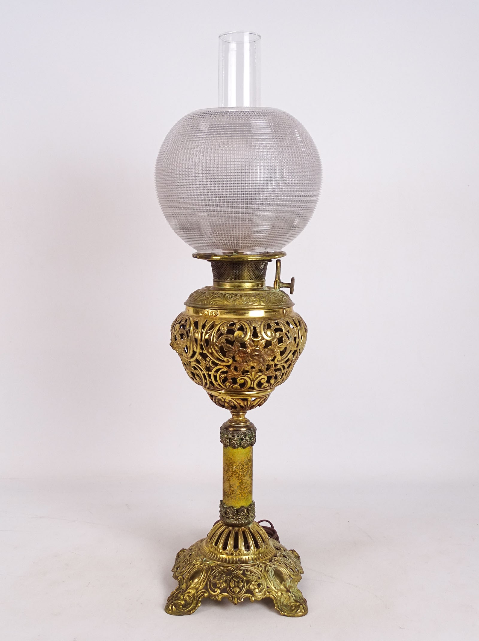 Bradley & Hubbard Lamp: Bradley & Hubbard brass table lamp with shade and chimney. 27" Ht.. Shade has some chips.