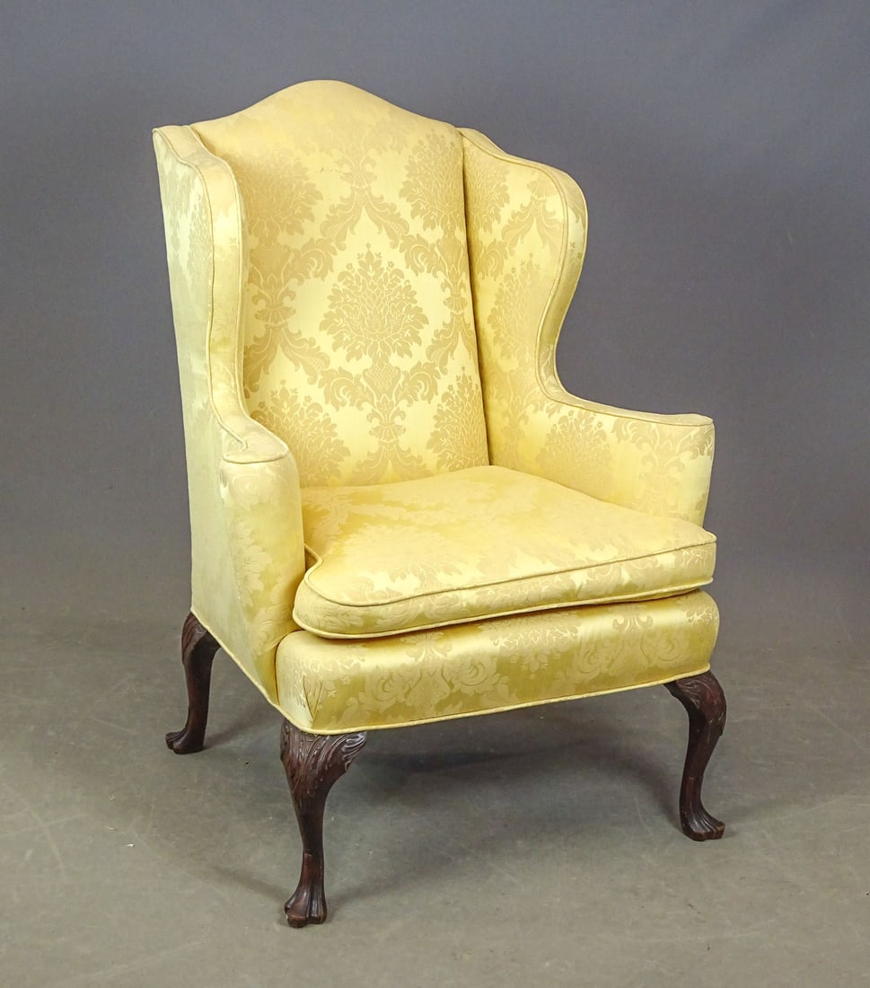 Chippendale Style Wing Chair: Chippendale style carved wing chair. Mahogany carved base. High quality upholstery.34" x 26" x 46" Ht..