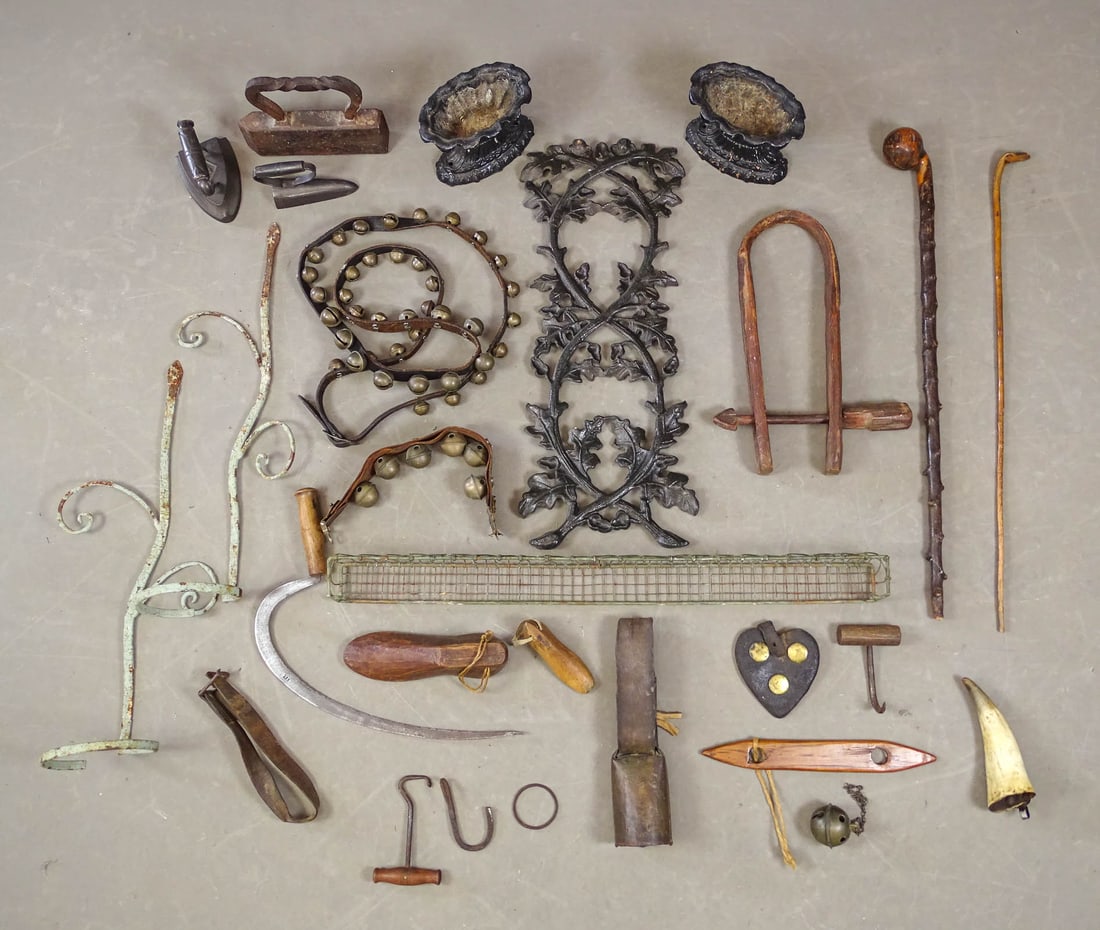 Primitive Lot: Misc. lot including: Sad irons, bells, cane, wooden shoes, horn, wall rack, pair iron plant holders, pair iron urns (8" W., 6" Ht.), iron element (28" W.).