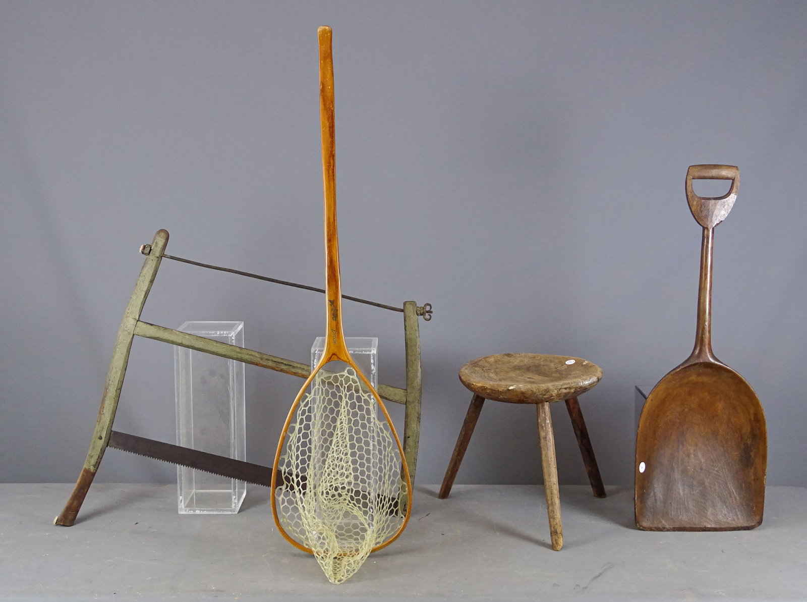 Primitive Lot: Primitive lot including: Saw (33" x 29"), wooden shovel (36" L.), 3 leg stool (13" D., 16" Ht.), Brodin fishing net (50" L.).
