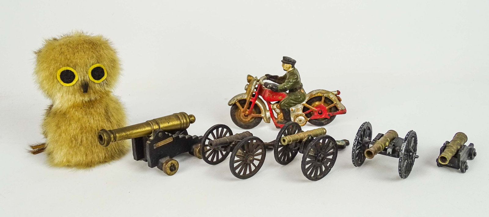 Toy Lot: Toy lot including: Owl (6" Ht.), cast iron Motorcycle toy (7" L.), (5) mini cannons (largest 6" L.).