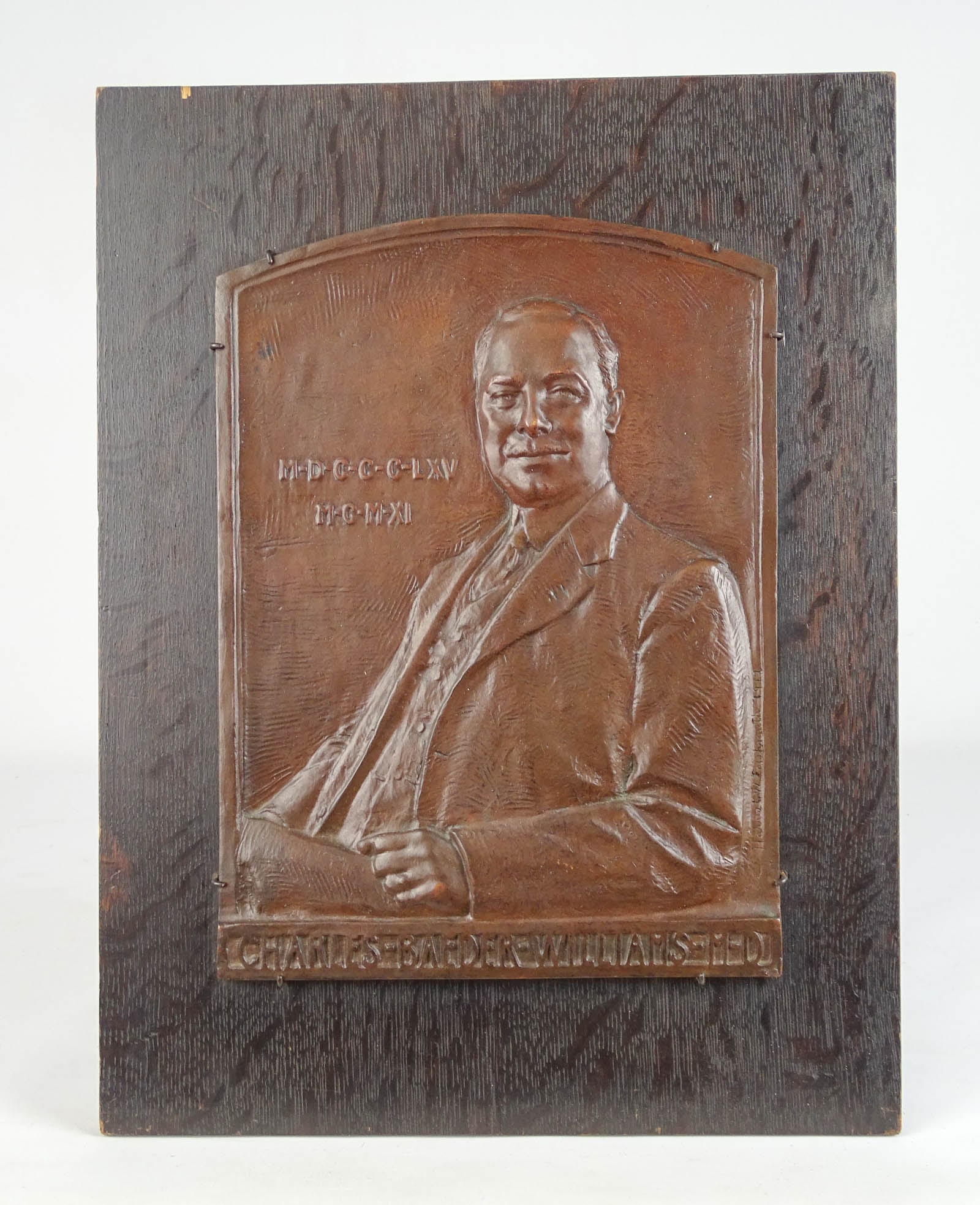 Bronze Plaque of Charles Baeder Williams M.D.: Early bronze plaque of "CHARLES BAEDER WILLIAMS M.D.". Mounted on oak panel. Overall 17" x 13".