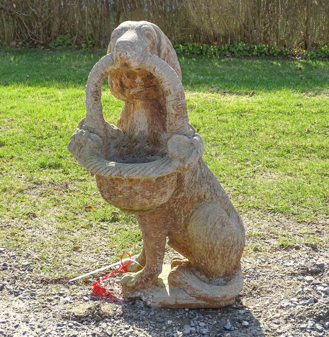 Poured Stone Dog: Poured stone garden dog with basket. Marked "1991 AL'S GARDEN ART INC.". Some loss to base.