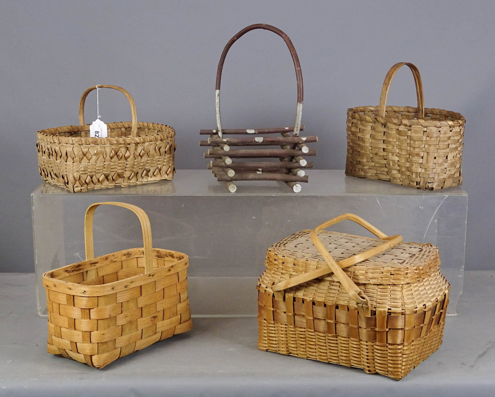 Basket Lot: Lot (4) early baskets (largest 14" x 10" x 9"), and Adirondack twig basket (15" Ht.).