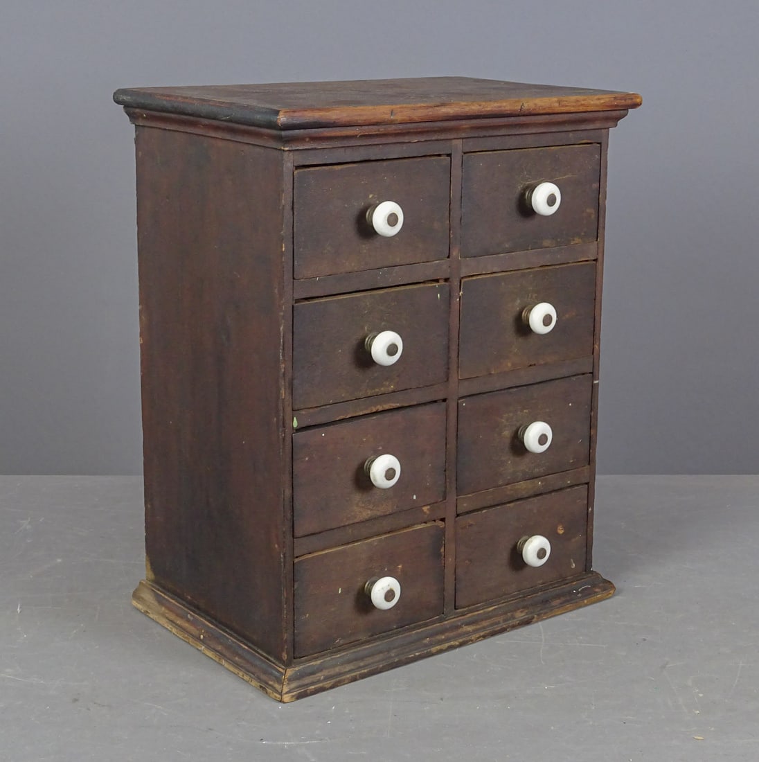 Table Top Cabinet: Early table top cabinet with (8) drawers.