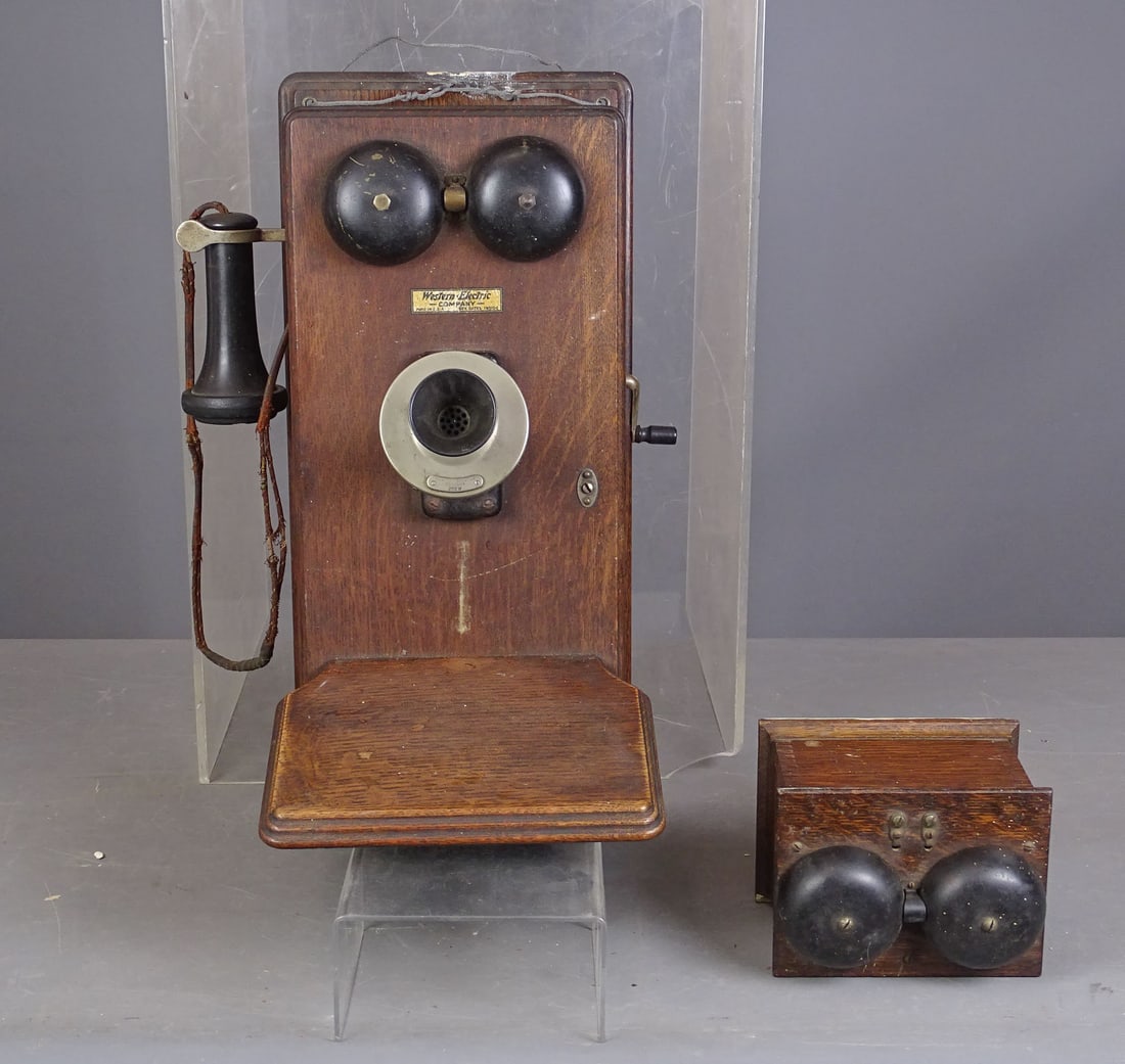 Antique Telephone: Antique Western Electric Company oak case telephone with bell. 20 1/2" x 9 1/2" x 13 1/2".