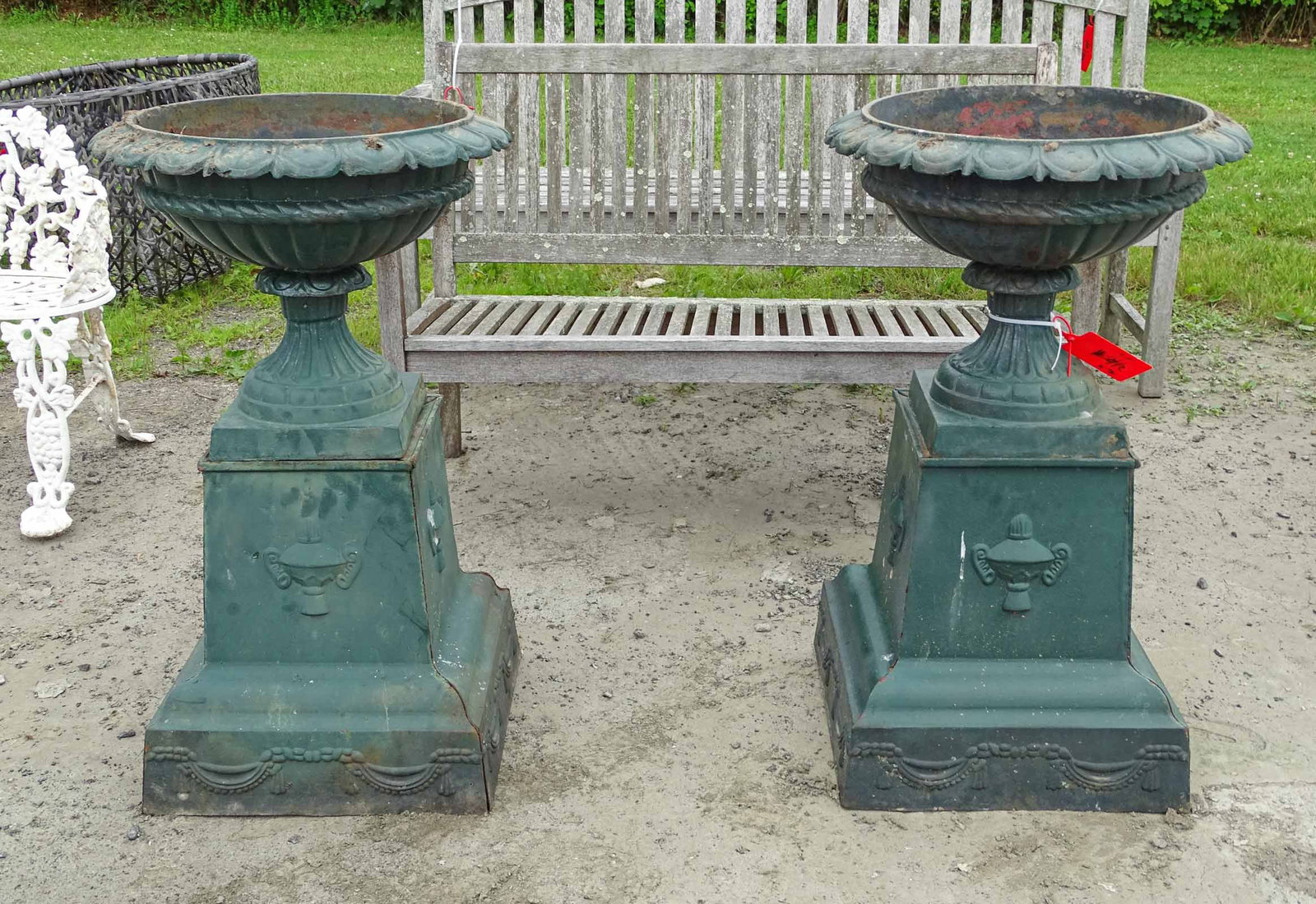 Pair Cast Iron Urns: Pair of cast iron urns on bases. 21" D., 36" Ht..