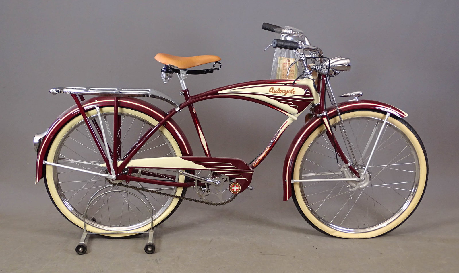 C. 1940's Schwinn Autocycle: C. 1941 26" Schwinn Autocycle Super Deluxe balloon tire bicycle. Restored. 19" frame. Mesinger saddle, Good Year whitewall tires, Stewart-Warner speedometer, EA horn, Miller kick stand, twin headlight