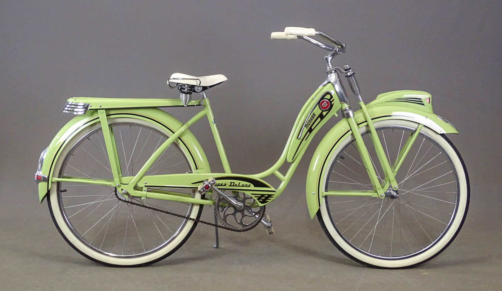 Monark Super Deluxe Bicycle: Monark Super Deluxe bicycle. Nice restored condition. Pastel, green and black. 19" frame. Rear rack, Monark pedals, springer front end.