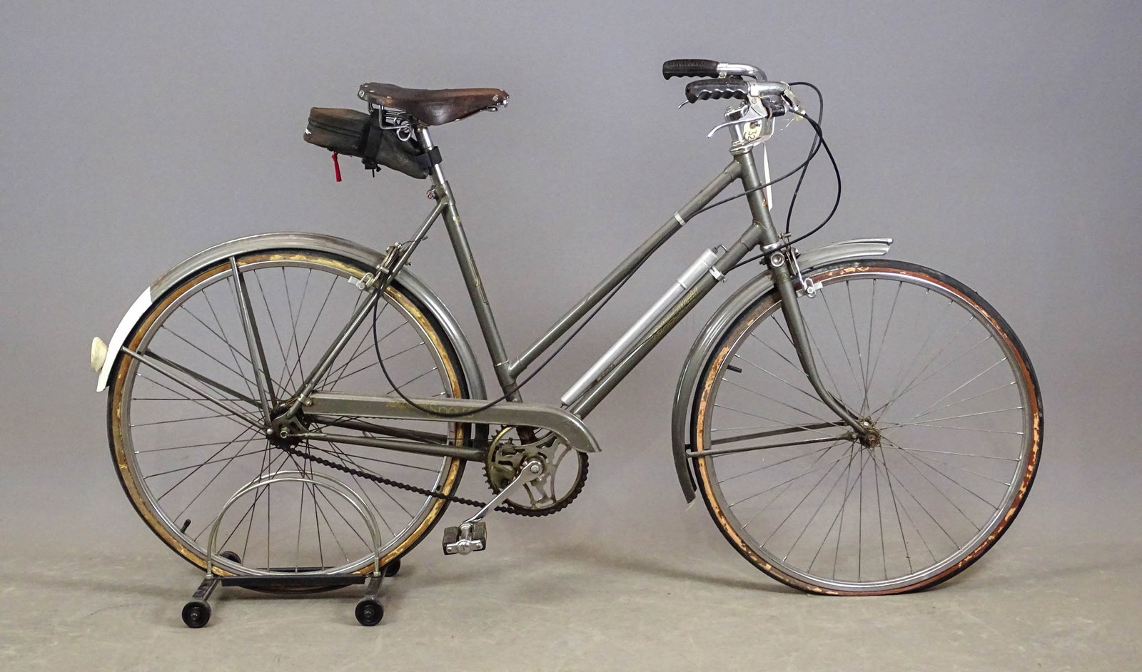 Raleigh Mixte Frame Bicycle: Raleigh (Made in England): Mixte frame. 1950s. 27" wheels with aluminum rims and hubs for 3-speed Sturmey Archer gearing system. The frame has a mounted air pump for the tires, a kick stand, and a