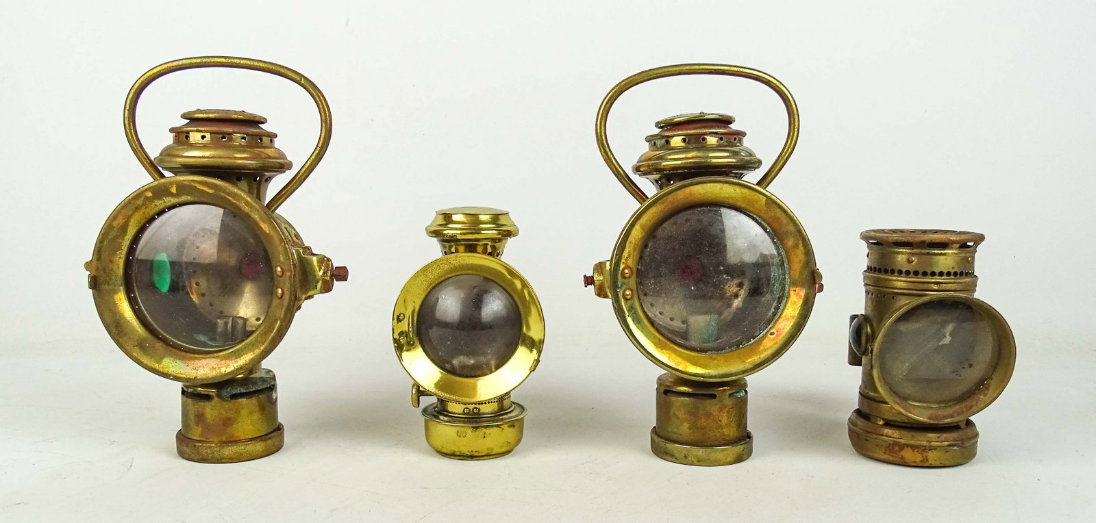 Bicycle Lamps: Lot (4) early brass bicycle lamps. Names include: The Pathfinder, (2) Neverouts, and unmarked. Tallest 9 1/2" Ht.. Good condition.