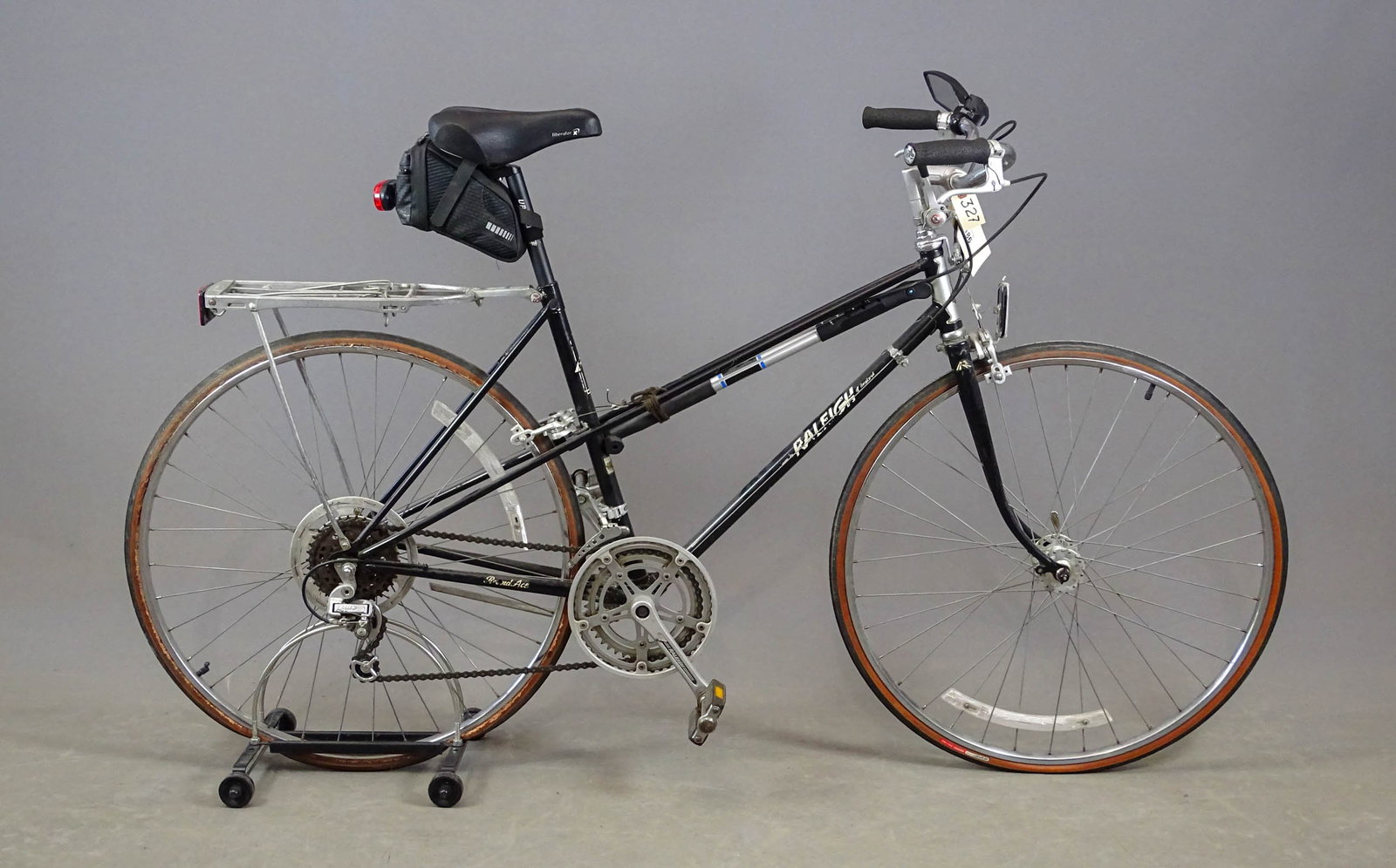 Raleigh Mixte Bicycle: Raleigh bicycle. Mixte frame: 1990s: this bicycle is equipped with a complete 5-speed Raleigh Suntour gear changing system that operates from a gear changer on the handlebars. There is a luggage rack