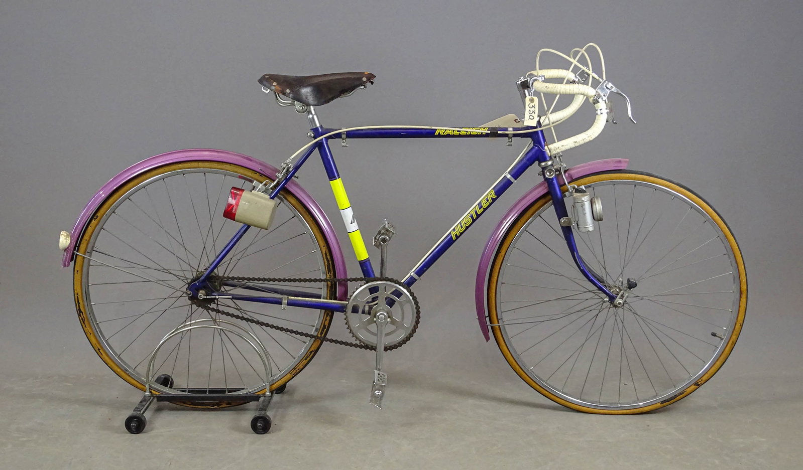 Raleigh Racing Bicycle: Raleigh racing bicycle, (Made in Nottingham, England - probably in 1990s). Purple frame, magenta metal fenders. Battery (no batteries) operated lights on front and rear of bicycle. 3-speed Sturmey