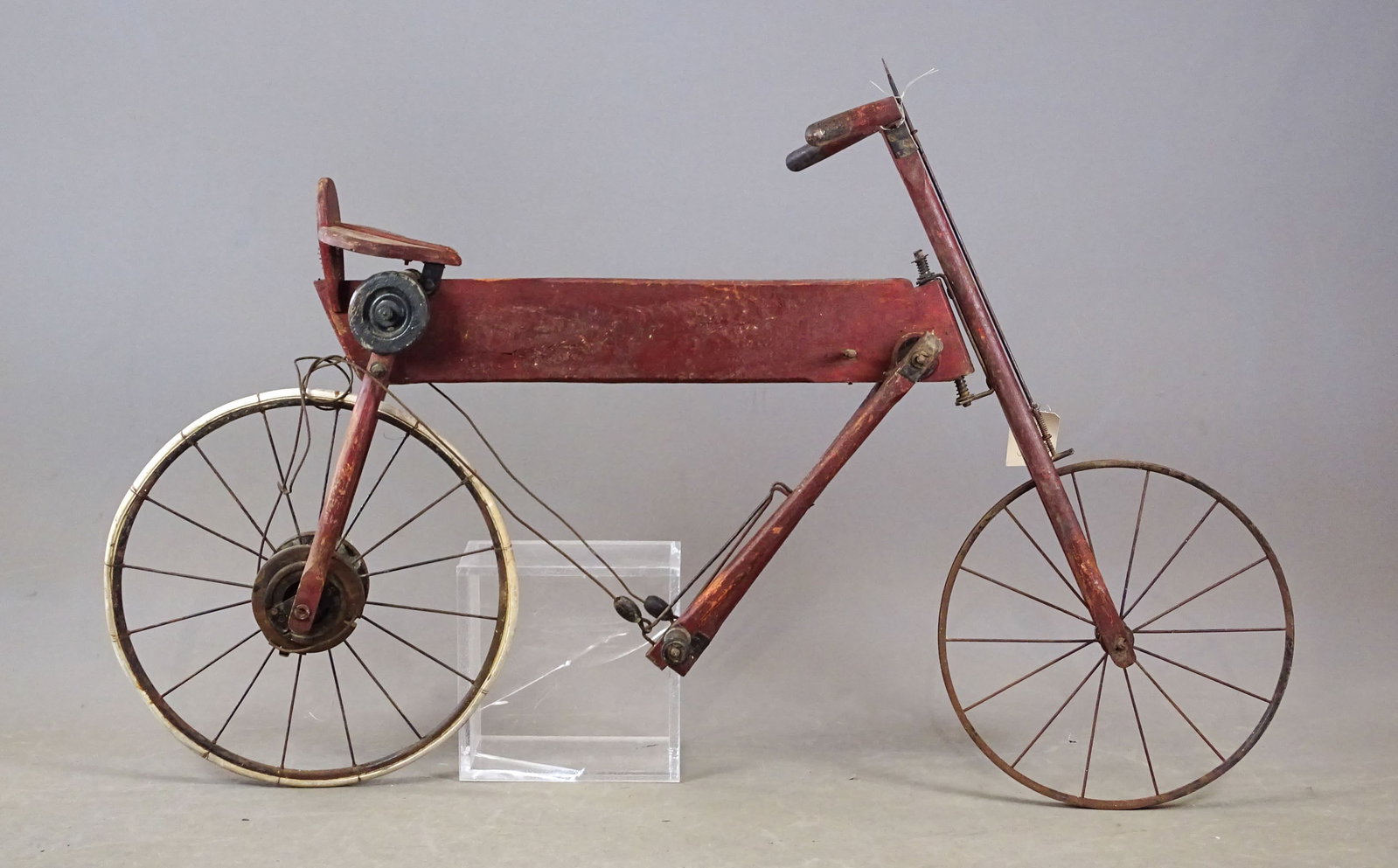 Early Wooden Child's Bicycle: Early wooden child's bicycle with pump action pedaling system. Comes with set of tires.