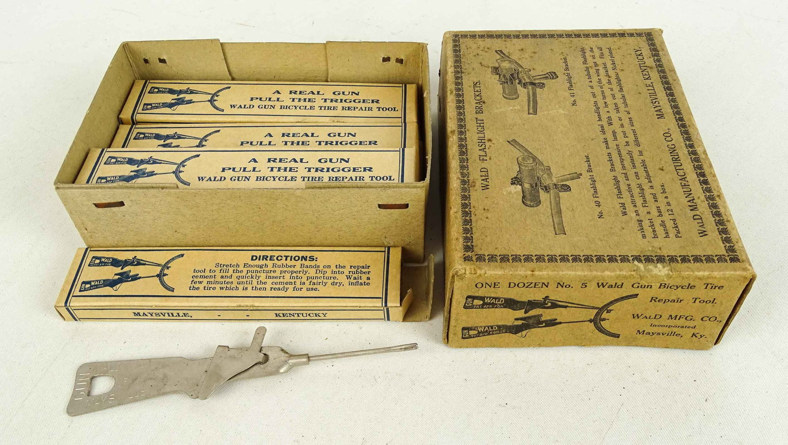 Misc. Lot: Lot (8) Wald "A Real Gun Pull the Trigger Wald Gun Bicycle Repair Tools" in original boxes. Includes empty Wald flashlight bracket. Good condition.