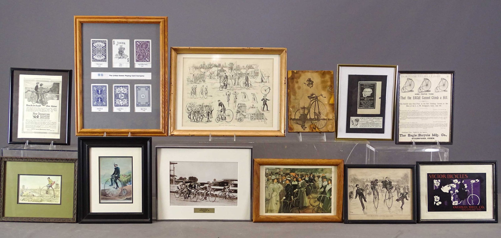 Bicycle Artwork Lot: Lot (12) pieces of bicycle related artwork: Includes playing cards, historical prints, advertisements, reproduction photo etc.. Largest frame overall 17 1/2" x 14". Gary Sanderson Collection.