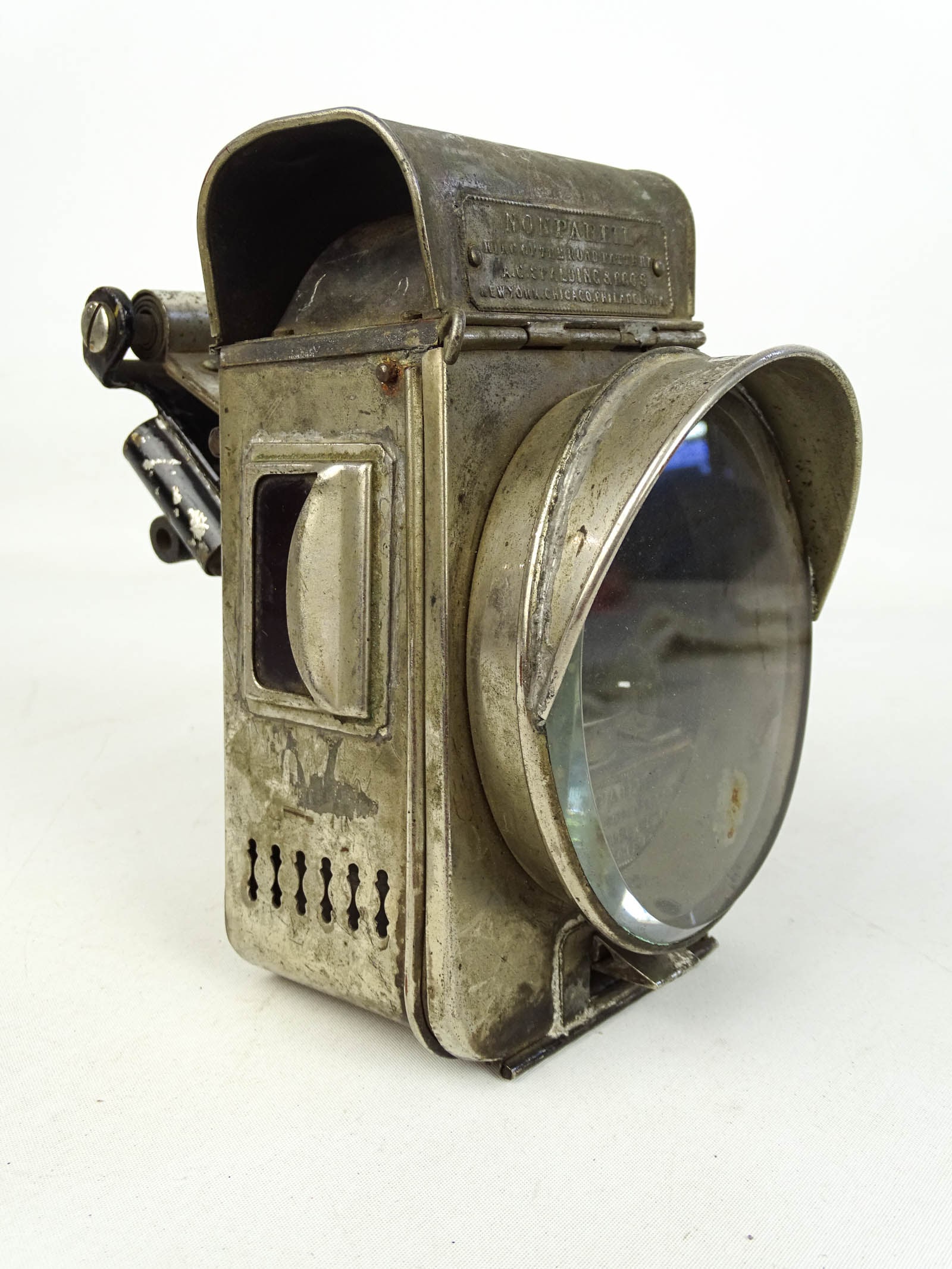Bicycle Hub Lamp: Bicycle hub lamp marked "NONPAREIL" (Philadelphia). 6 3/4" Ht.. Fair condition. Gary Sanderson Collection.