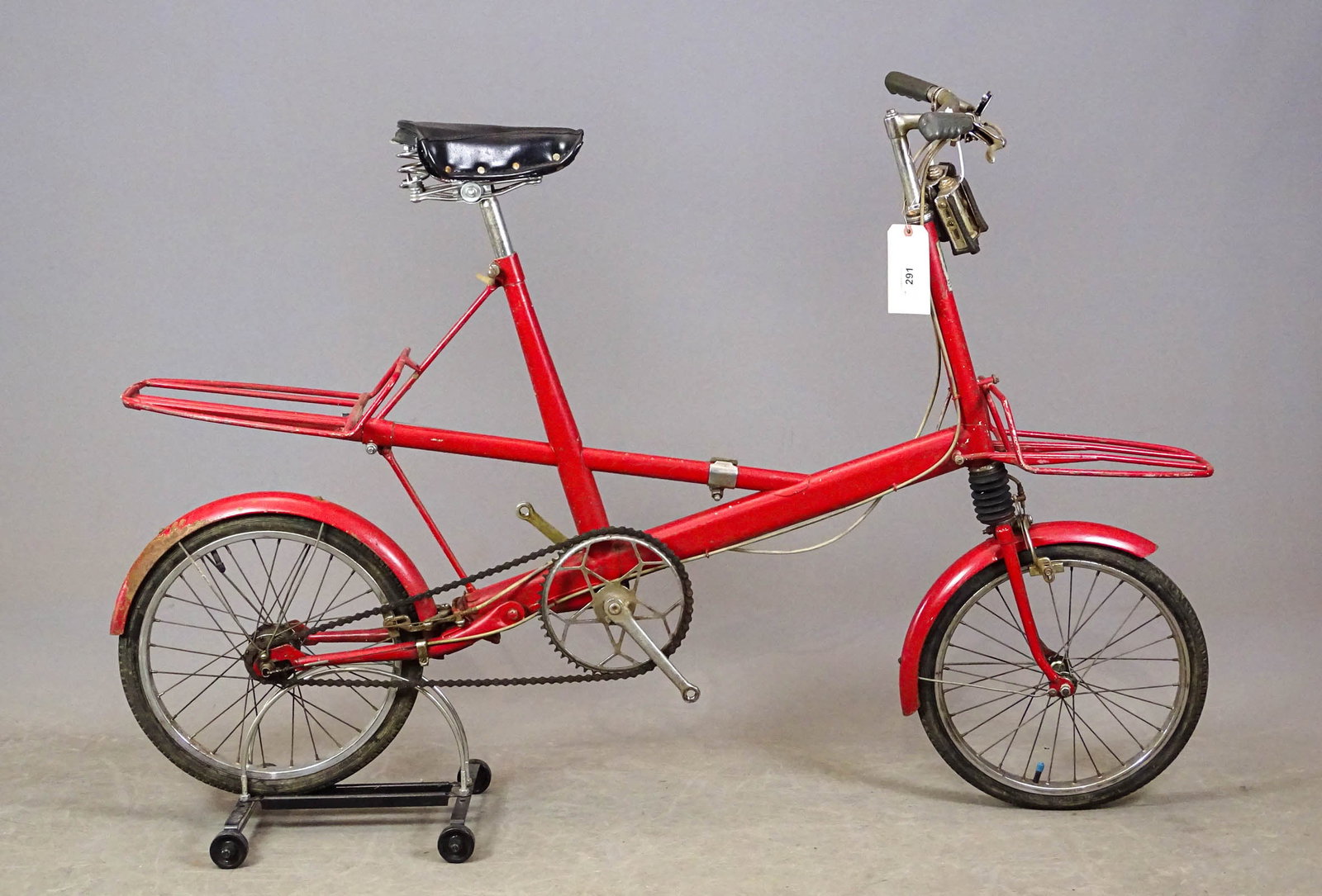 1965 Moulton Bicycle: 1965 Moulton 4-Speed red bicycle. SN#65110028. Full suspension commuter bicycle. Made in England. Has correct side stand. Fair condition.