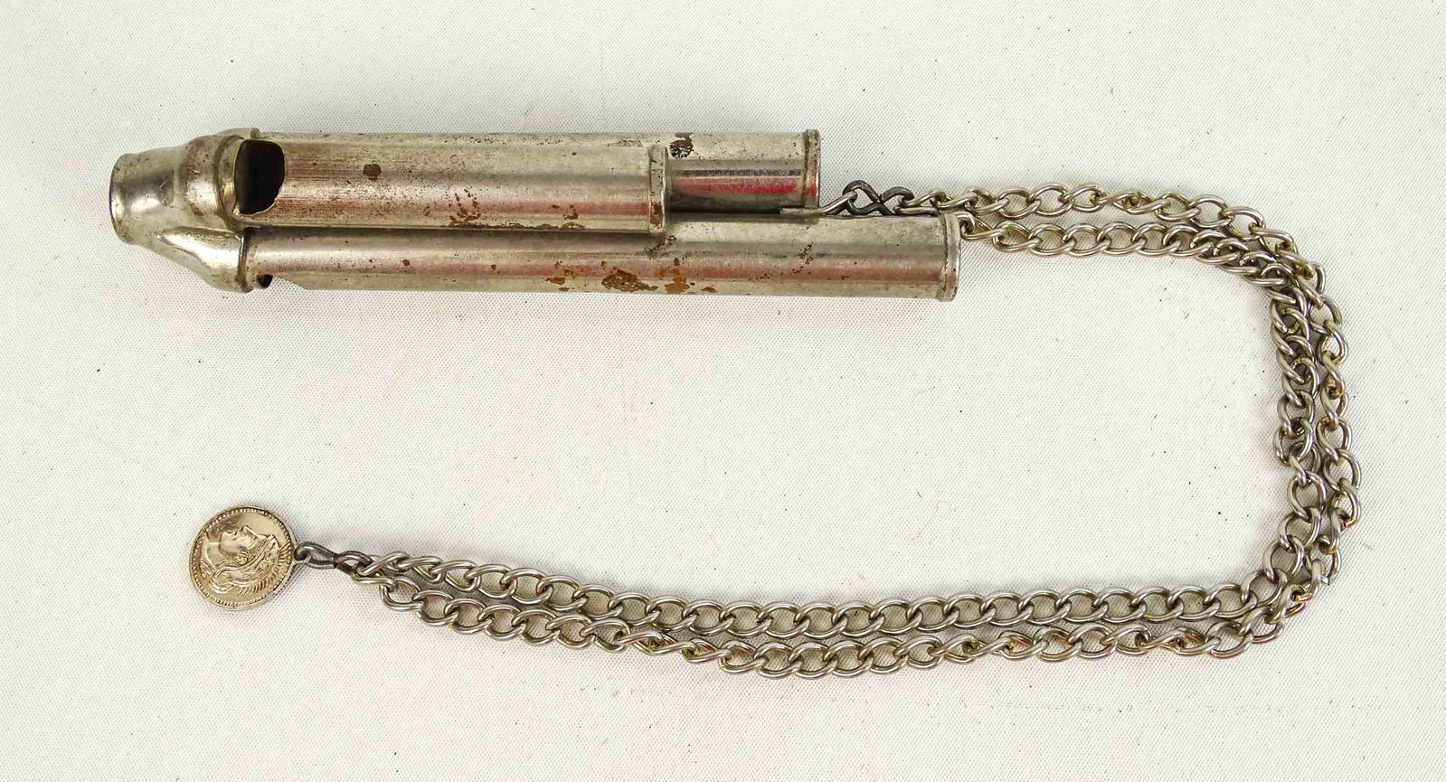 Whistle: 3 tone whistle (5 1/2") with watch chain with Roman coin. 18" overall L.. Good condition.