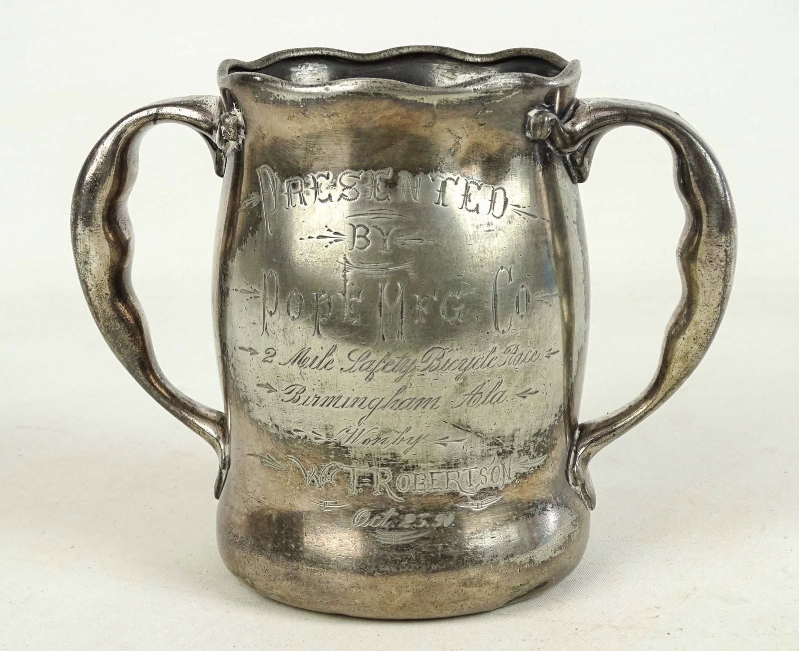 Pope Trophy: Pope Mfg. Co. trophy "Presented by Pope Mfg. Co. 2 Mile Safety Bicycle Race Birmington Ala, won by W.T. Robertson Oct. 25 90" (1890). 5 3/4" Ht.. Fair condition.