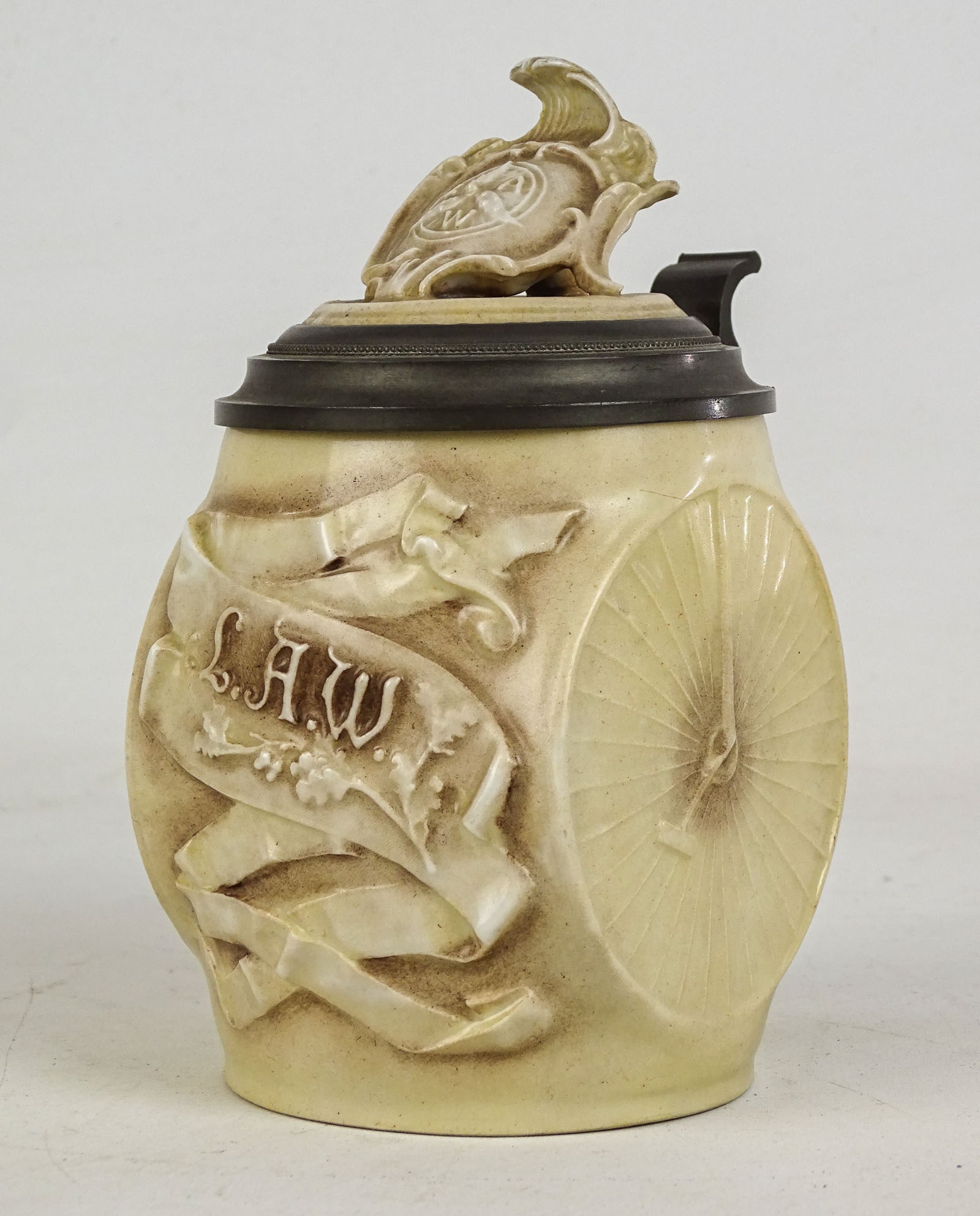 L.A.W. Stein: L.A.W. stein, Musterschutz made in Germany, 1/2 liter. 6 3/4" Ht.. Note interior lithophane depicting riding gent crashing into a lady with the boys watching. Good condition.