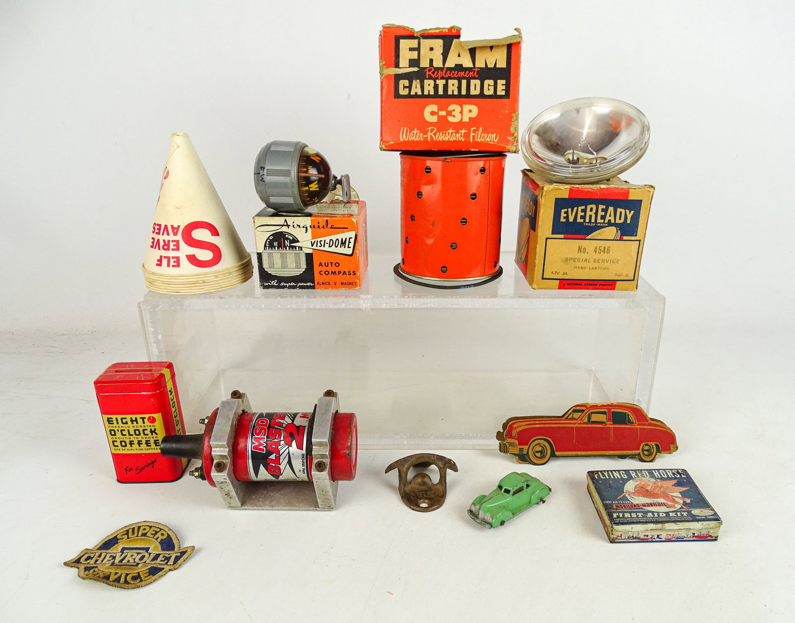 Misc. Lot: Lot including: Eveready lamp in box, Auto Compass in box, Fram cartridge in box, oil cones, Eight O' Clock tin bank, Mobil first aid tin kit, "MSD BLASTER 2", bottle opener,Tootsie toy car. Fair-Good
