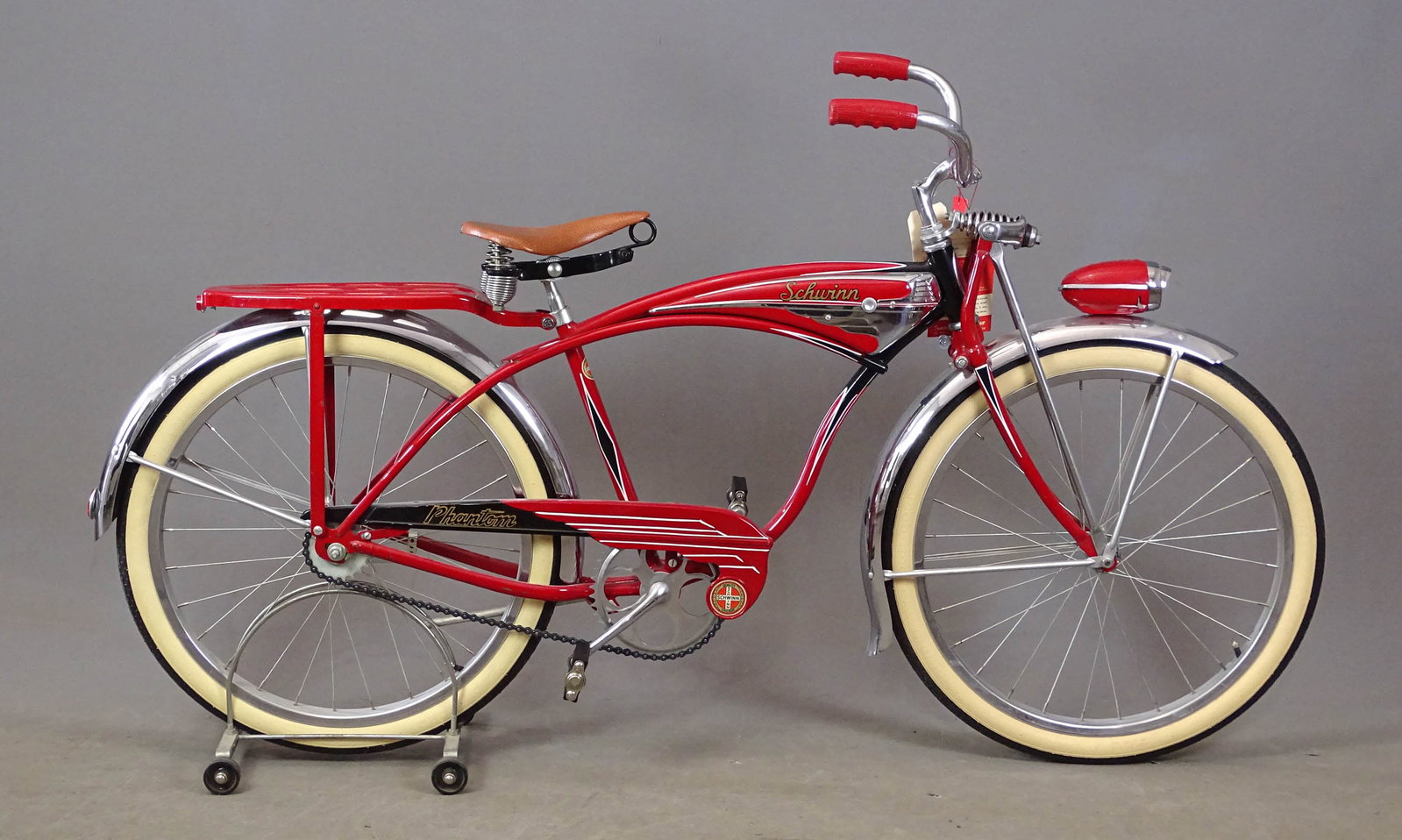 C. 1950's Schwinn Phantom Youth Bicycle: C. 1950's Schwinn 24" Phantom youth balloon tire bicycle. Schwinn saddle, Delta Rocket Ray front light, locking fork, Schwinn Typhoon Cord whitewall tires. Original condition.