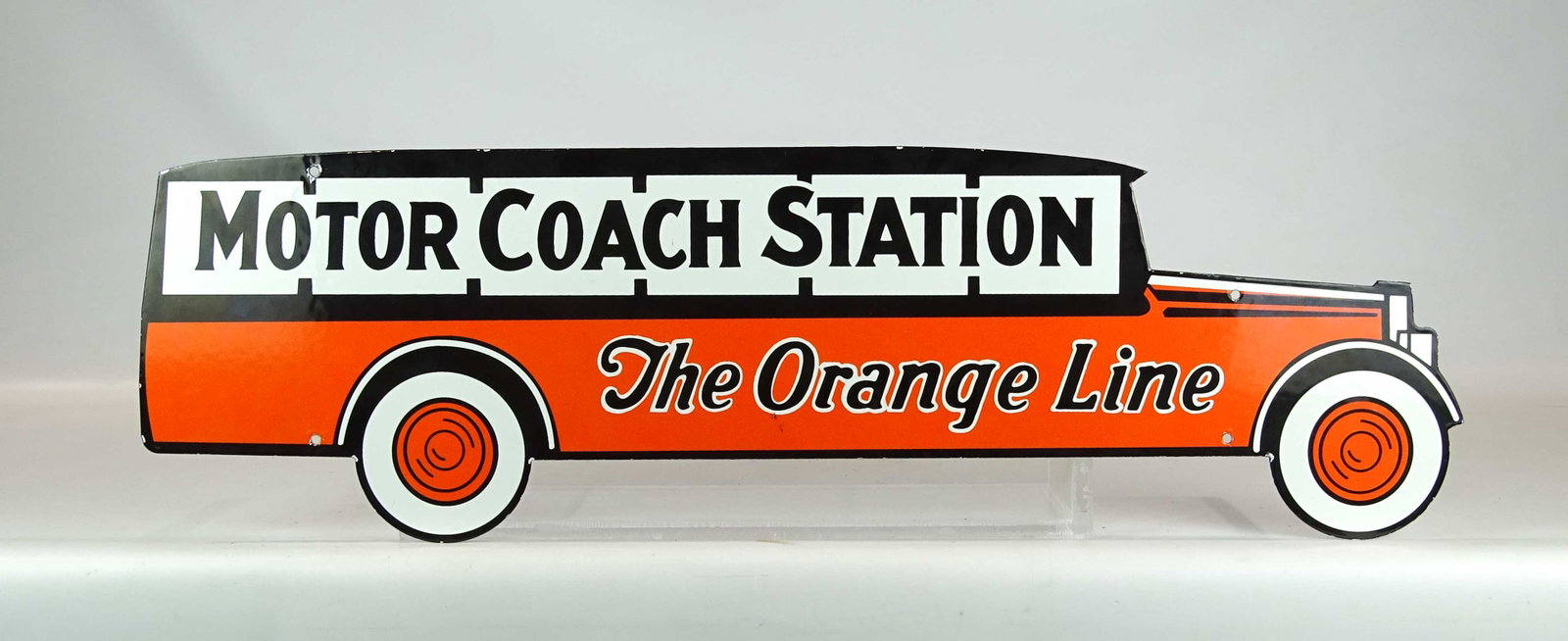 Motor Coach Station Sign: Enameled sign "MOTOR COACH STATION THE ORANGE LINE". 10 1/2" x 35 1/2".