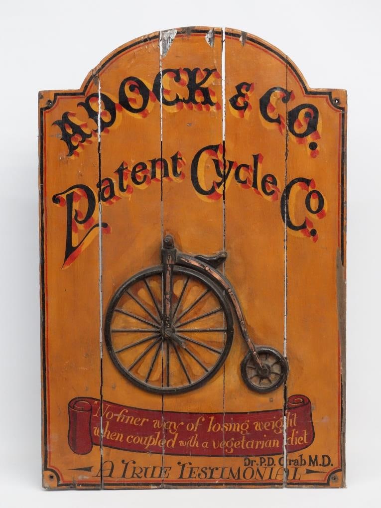 Sign: Wooden, polychrome painted trade sign with high wheel. Marked "Adock & Co., Patent Cycle Co., "No Finer Way Of Losing Weight When Coupled With A Vegetarian Diet....". 23" x 35 1/2" Ht.. Some paint