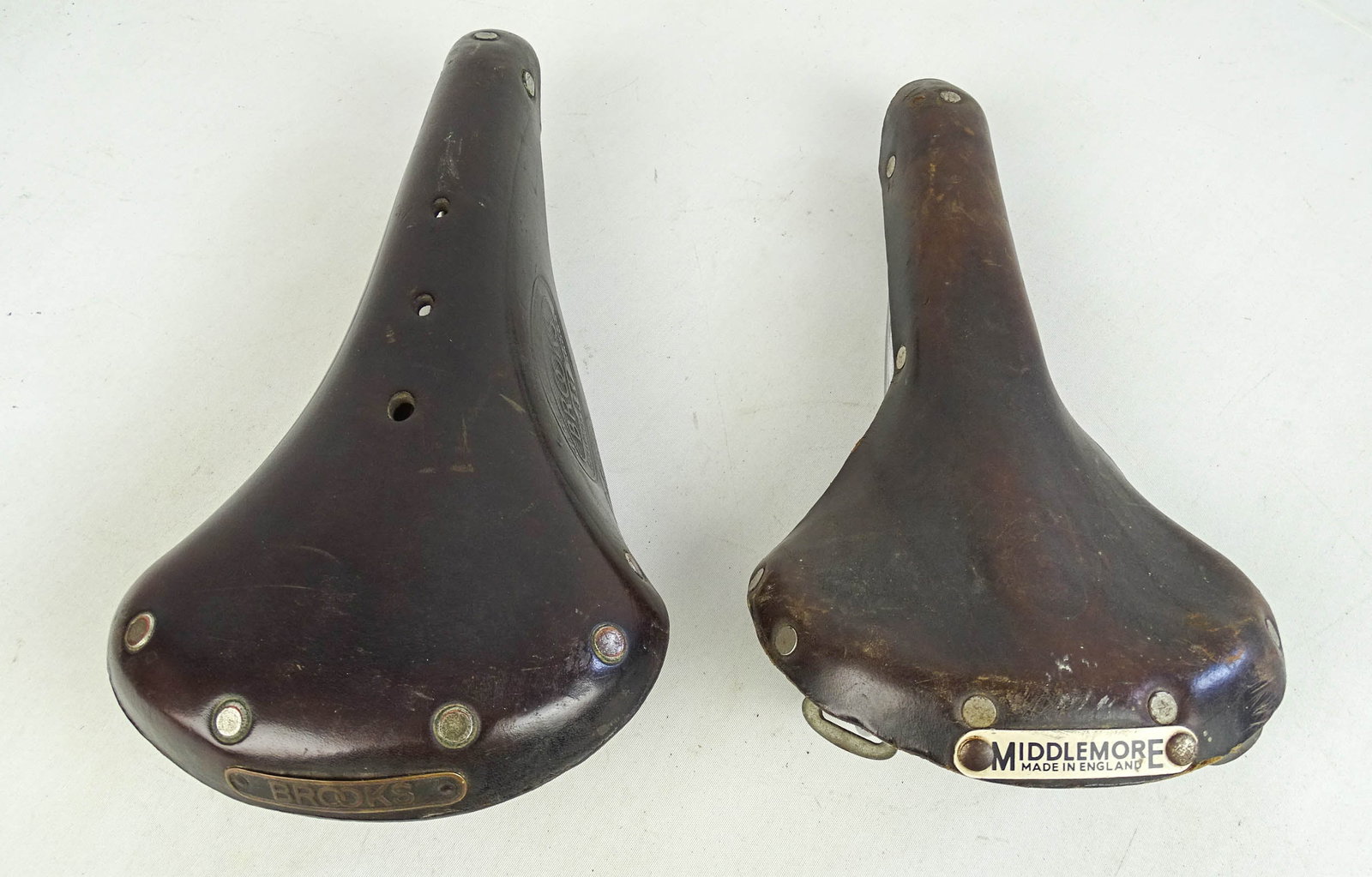 Brooks Middlemore Saddles: Brooks "Champion" B37 model leather saddle (1950's) and a Middlemore leather racing saddle circa 1960's. (2 items). Good condition. Glenn Eames Collection Burlington Vermont.