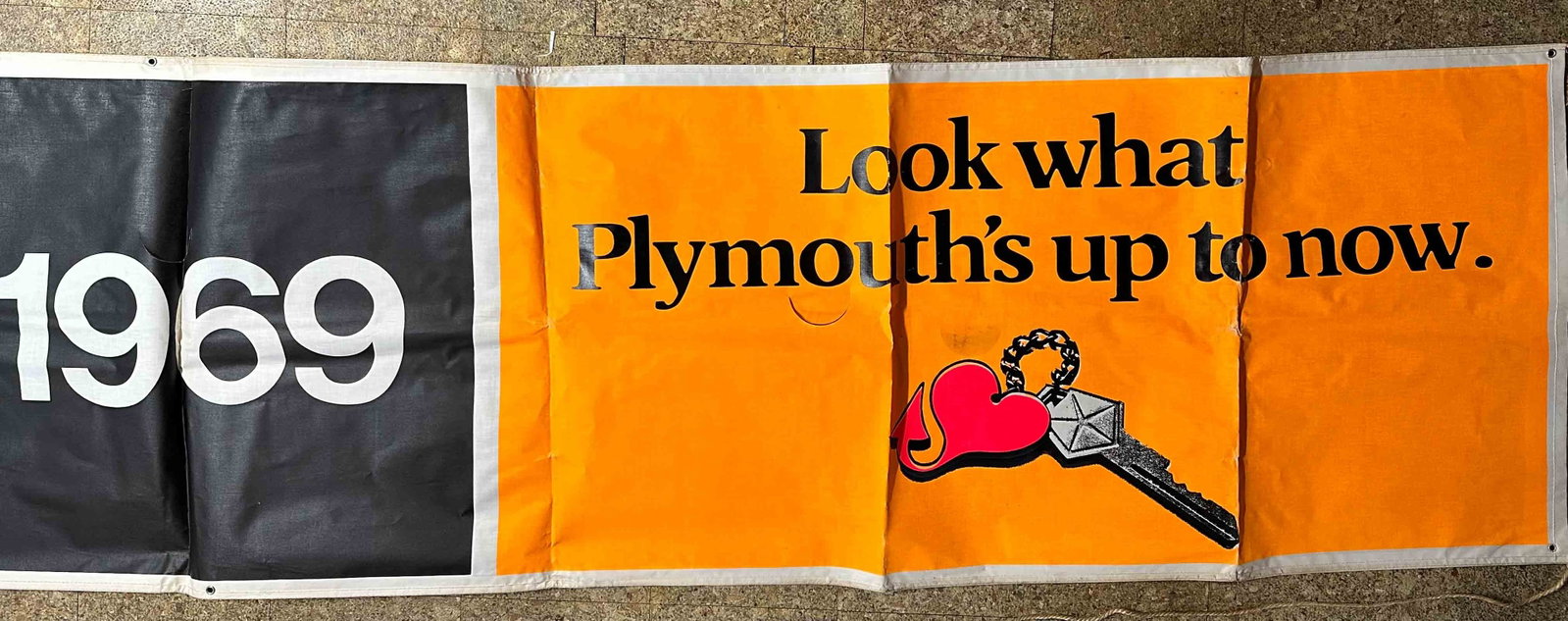 Plymouth Lot: Original factory very large 1969 Plymouth outdoor hanging banner, sisal rope ties, 14 ‘ 6" long x 34" wide and two Rapid transit large window decals, 25 x 28 each.