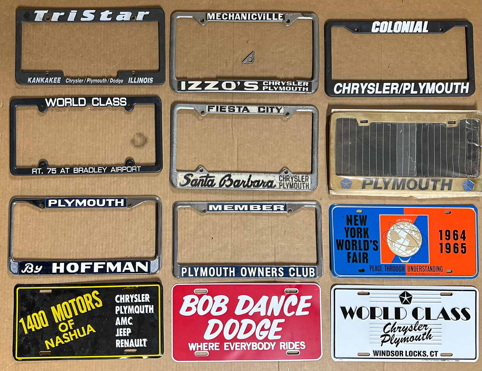 Mopar Lot: Collection of Mopar related license pate frames and dealer license plate inserts, many are NOS.