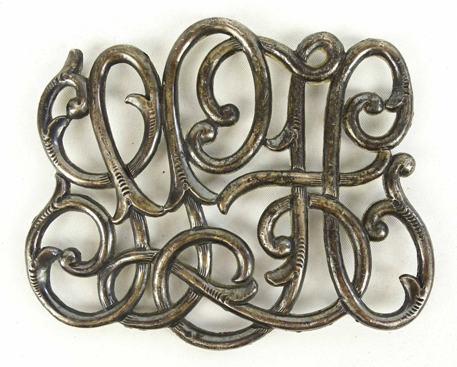 Radiator Monogram: Nickel plated cast radiator monogram. 5 1/2" x 4 1/2". Good condition.