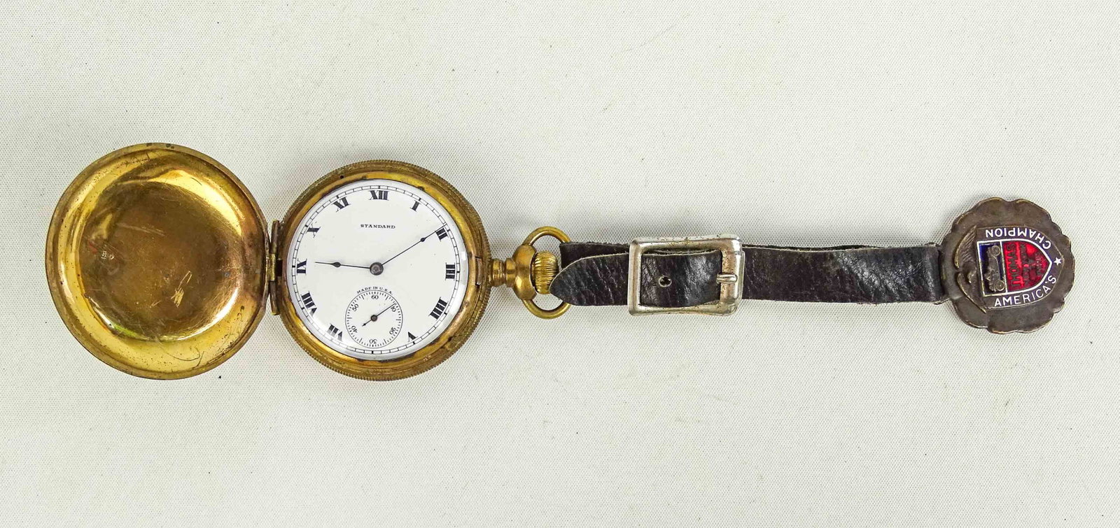 14 Karat Gold Watch: 14 karat gold filled watch case. Double case. Thomas Flyer fob (Whitehead & Hoag). Good condition. Unsure if working.