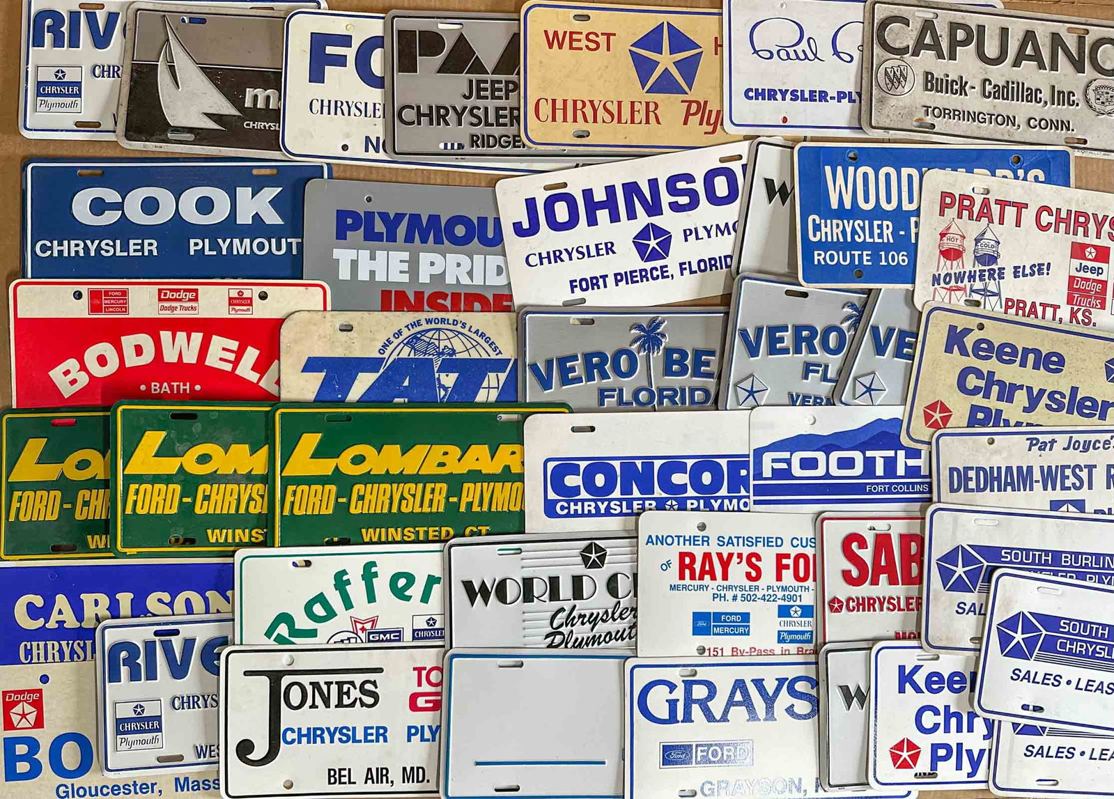 License Plate Lot: Collection of license plate frames and dealer plate fillers, most are Mopar related.