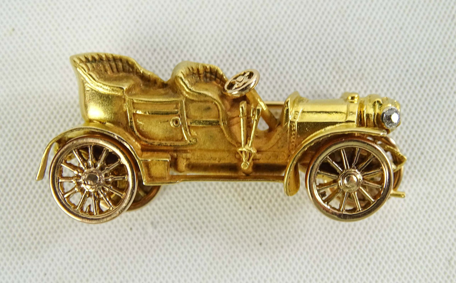 Gold and Diamond Auto Pin: Gold and diamond automobile pin with rotating wheels. 1". Good condition.