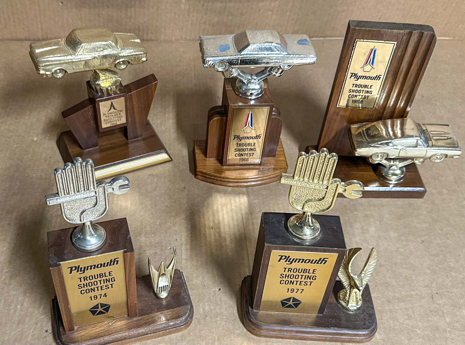 Mopar Lot: Five Mopar Trouble Shooting Trophy Awards - 1962, 1966, 1968, 1974, 1977.