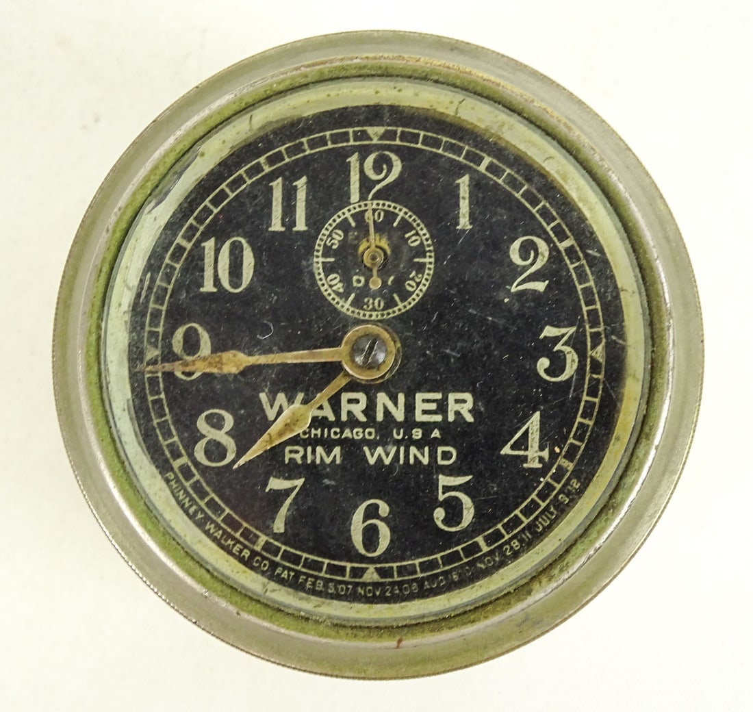 Warner Clock: Warner black face clock. Good condition.
