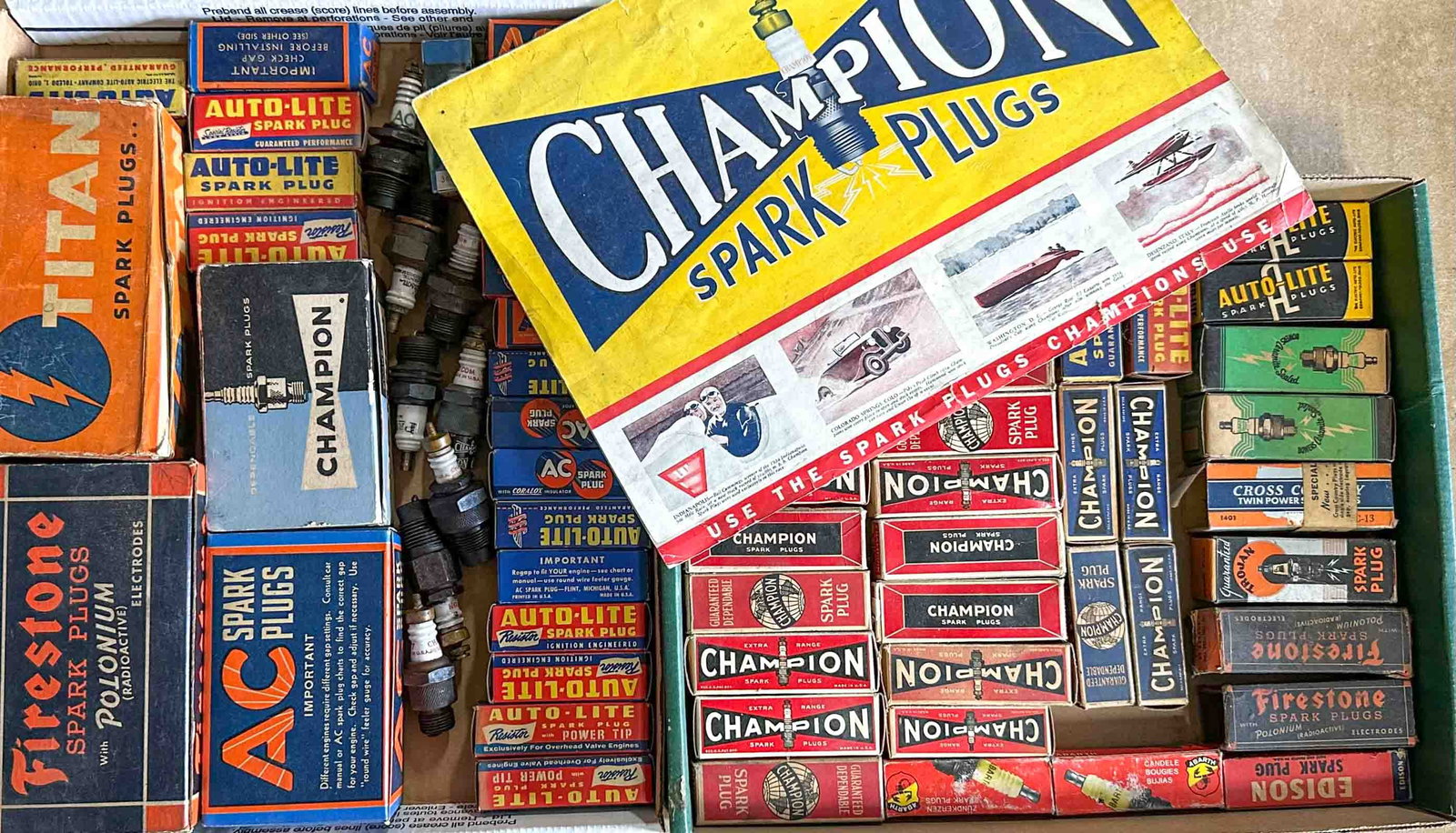 Spark Plugs Lot: Spark plugs - two boxes of NOS plugs and a 1934 Champion application chart.