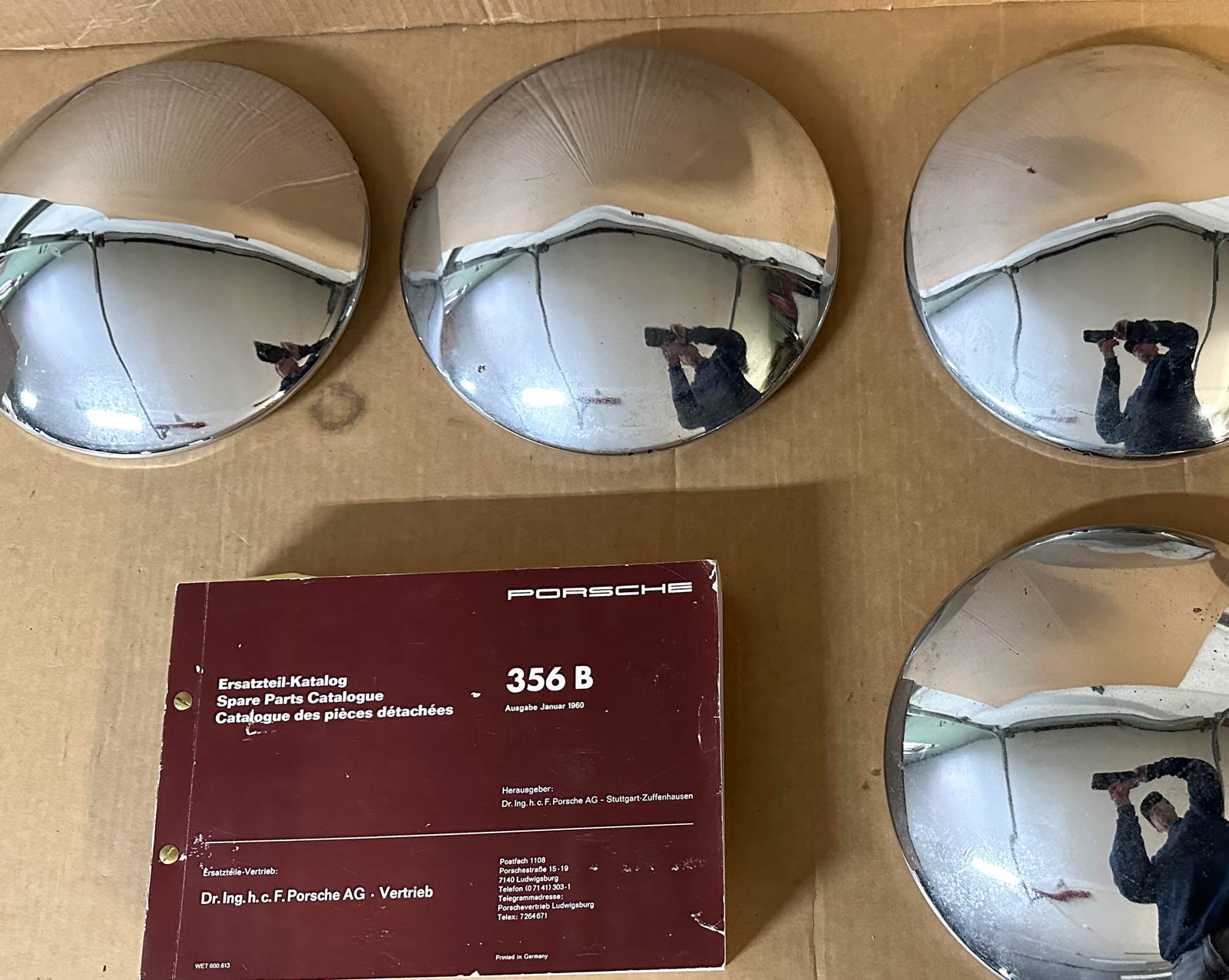 Porsche Catalog Lot: 1960 Porsche 356B parts catalog, 2.25 inches thick and four 356 hubcaps.