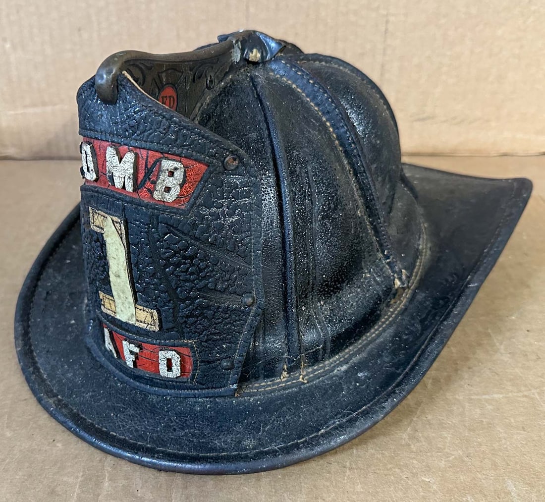 Fire Helmet: Decorative vintage fire helmet with brass FD badge on front peak.