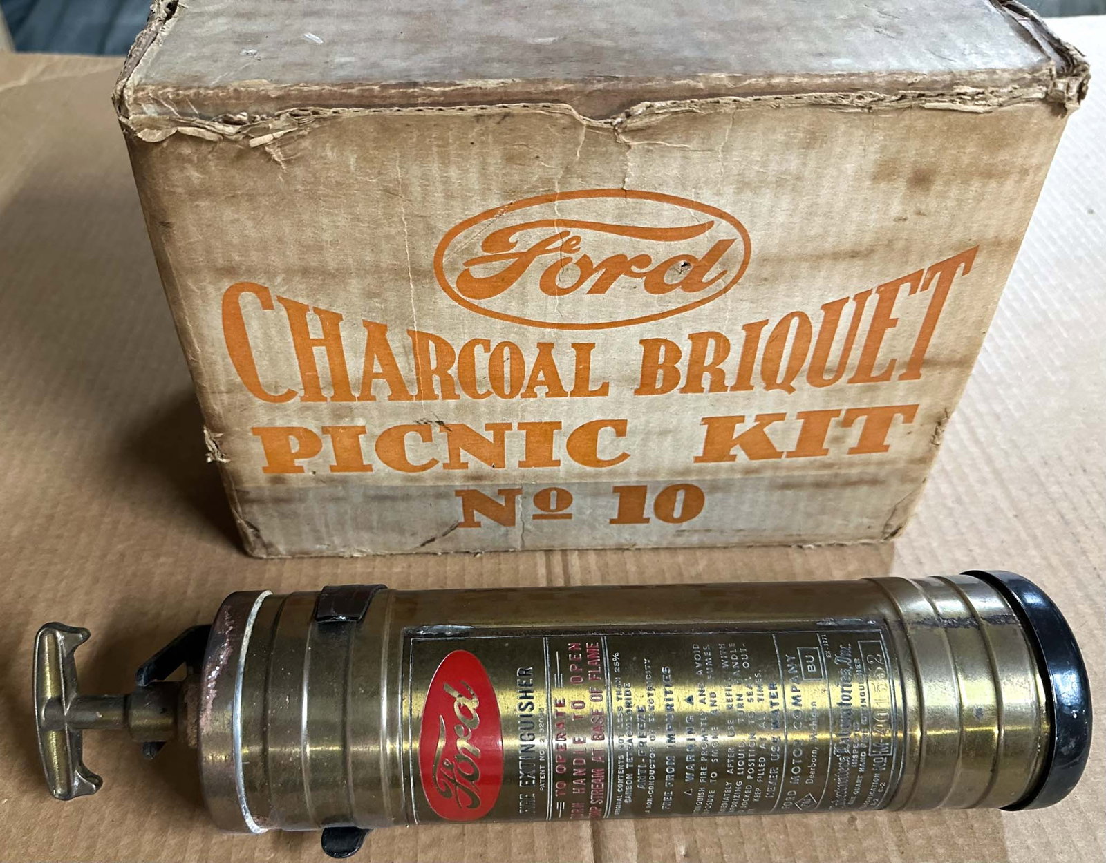 Ford Picnic Grill: 1920's - 1930's Ford Charcoal Briquet picnic grill, was sold by Ford dealers, used charcoal briquet from Ford's lumber areas, original box, 11.5 x 8 x 8.5 high and Ford script fire extinguisher, 13